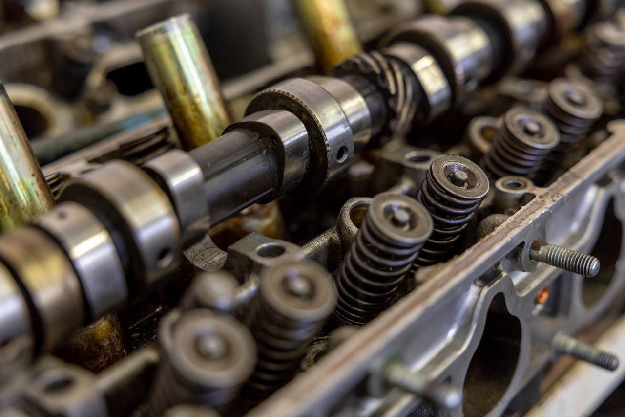 Detailed view of an engine camshaft and valve springs, showcasing mechanical precision.